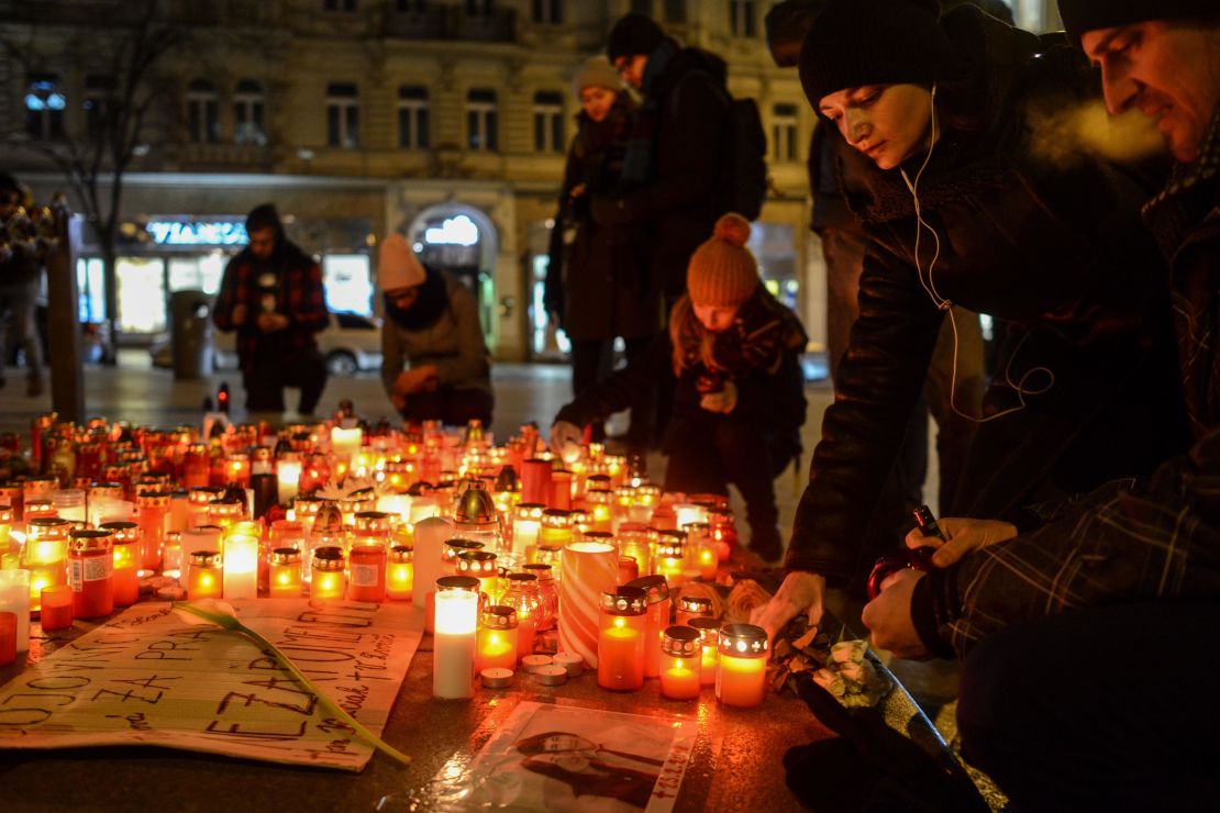 Slovak mourners light candles for the murdered couple.