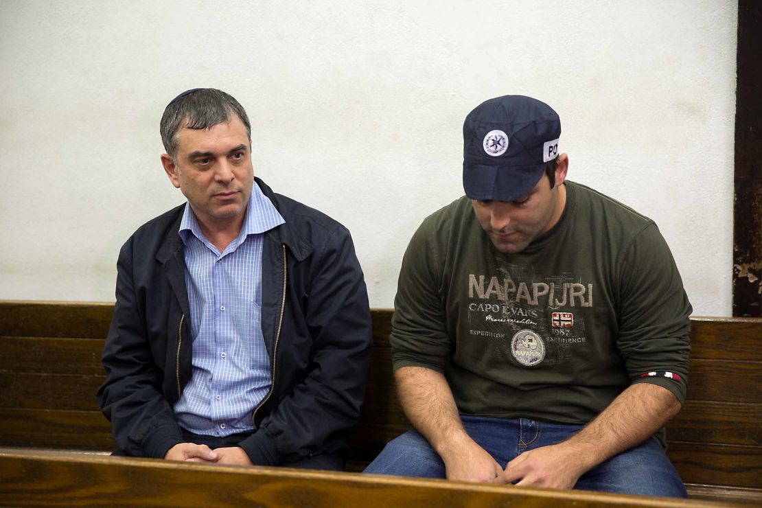 Shlomo Filber (L) sits in court during his remand in Tel Aviv on February 18.