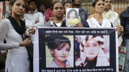 Fans of Bollywood actress Sridevi hold posters as they wait outside her residence to pay their last respects in Mumbai, India, Wednesday, Feb. 28, 2018. Dubai investigators on Tuesday closed the case into the death last weekend of Indian movie icon Sridevi, calling it an accidental drowning. The 54-year-old Sridevi, who was known by only one name, drowned in a hotel bathtub after losing consciousness, officials said. (AP Photo/Rafiq Maqbool)