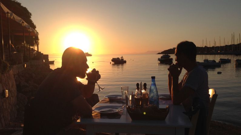 <strong>Sundowners: </strong>Quayside dining with the sun setting over the Ionian is one of the pleasures of Sivota life.