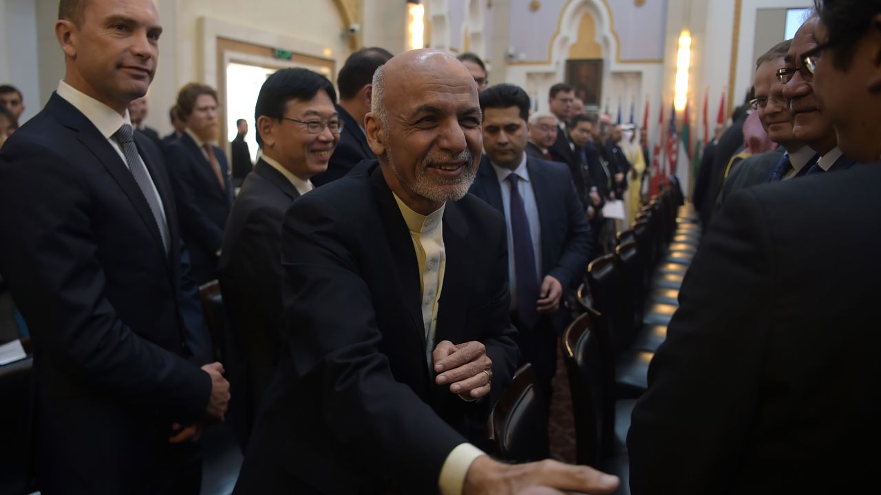 Afghan President Ashraf Ghani shakes hands with a foreign delegate at at talks in Kabul on February 28.