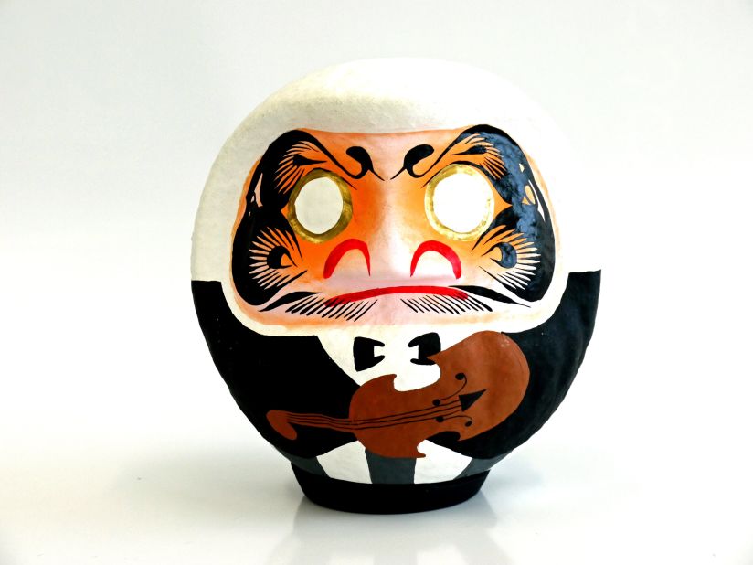 While traditionally painted red, Daruma dolls can now be found sporting more contemporary designs. This doll was designed specifically for the Gunma Symphony Orchestra.