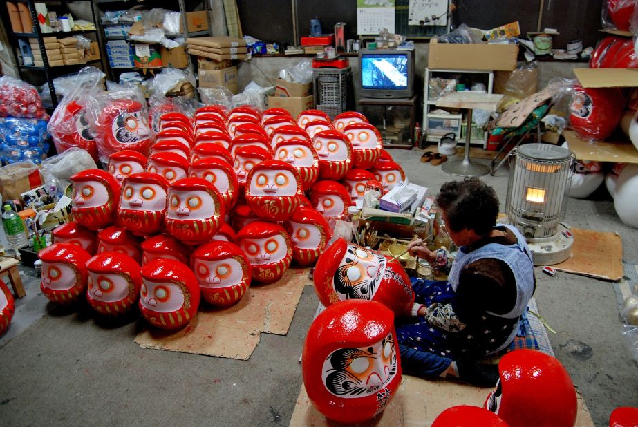 Demand for daruma dolls soars around the New Year, when family members pitch in to meet production targets.