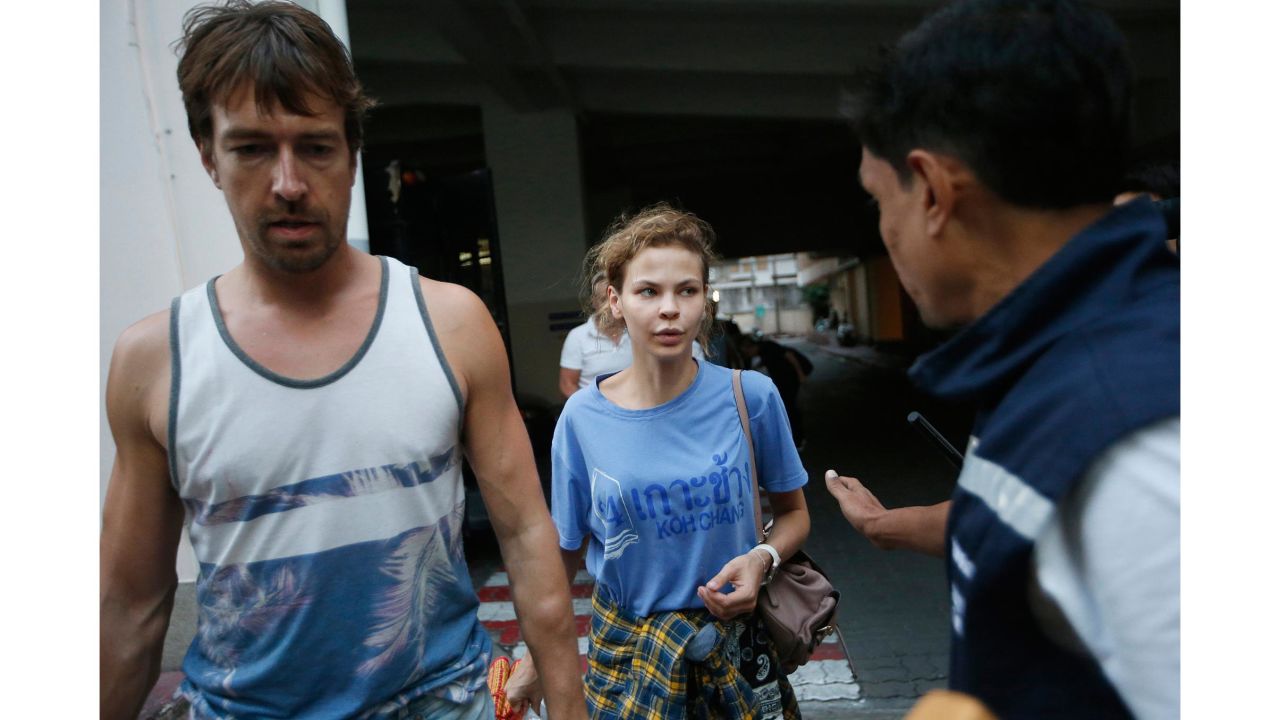 Anastasia Vashukevich, center, and Alexander Kirillov, left, arrive at the immigration detention center in Bangkok on February 28.