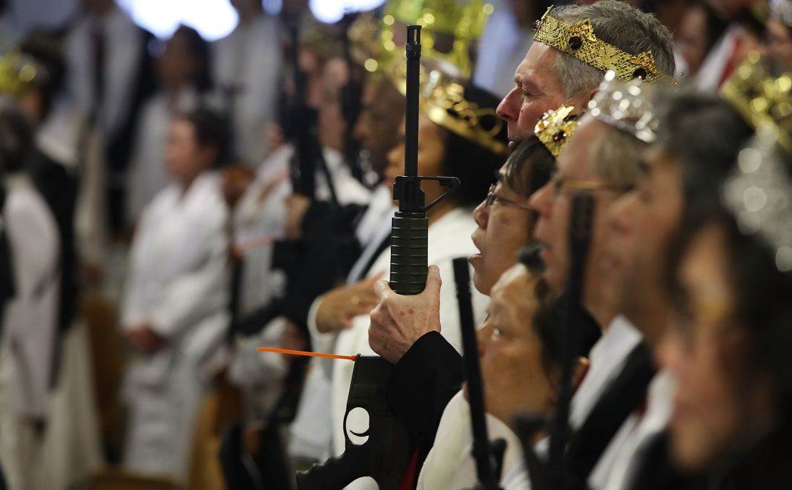 Couples hold AR-15 rifles and other guns during a ceremony at the Sanctuary Church on Wednesday in Newfoundland, Pennsylvania. 