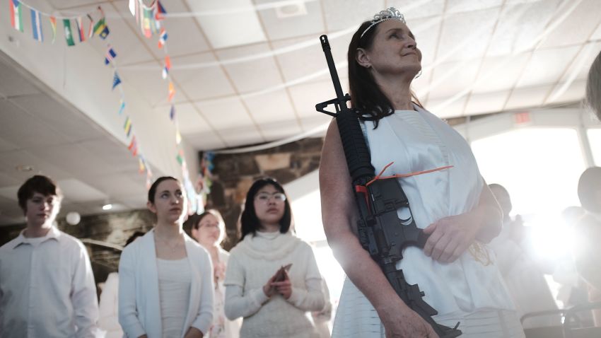 NEWFOUNDLAND, PA - FEBRUARY 28:  A woman holds an AR-15 rifle during a ceremony at the World Peace and Unification Sanctuary in Newfoundland, Pennsylvania on February 28, 2018 in Newfoundland, Pennsylvania. The controversial church, which is led by the son of the late Rev. Sun Myung Moon, believes the AR-15 symbolizes the "rod of iron" in the biblical book of Revelation, and it has encouraged couples to bring the weapons to a "commitment ceremony" or "Perfection Stage Book of Life Registration Blessing". Officials in the rural area in the Pocono Mountains have reportedly told elementary school parents that their children will be relocated on Wednesday to accommodate the AR-15 ceremony. The semiautomatic rifles are similar to the weapons used in a Florida high school shooting two weeks earlier.  (Photo by Spencer Platt/Getty Images)