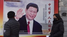 People walk past a poster of Chinese President Xi Jinping beside a street in Beijing on February 26, 2018.
Xi Jinping's tightening grip on China had already earned the leader comparisons to Mao Zedong, but they came into even sharper focus after the party paved the way for him to assume the presidency indefinitely. / AFP PHOTO / GREG BAKER        (Photo credit should read GREG BAKER/AFP/Getty Images)