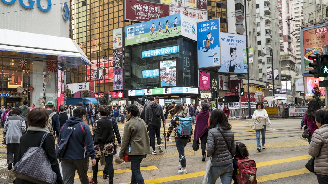 People go about their daily routines in Causeway Bay, Hong Kong.