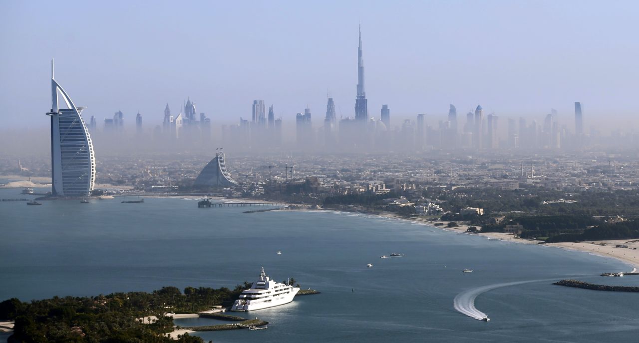 The Burj Khalifa soars up from downtown Dubai with the Burj Al Arab in the foreground.