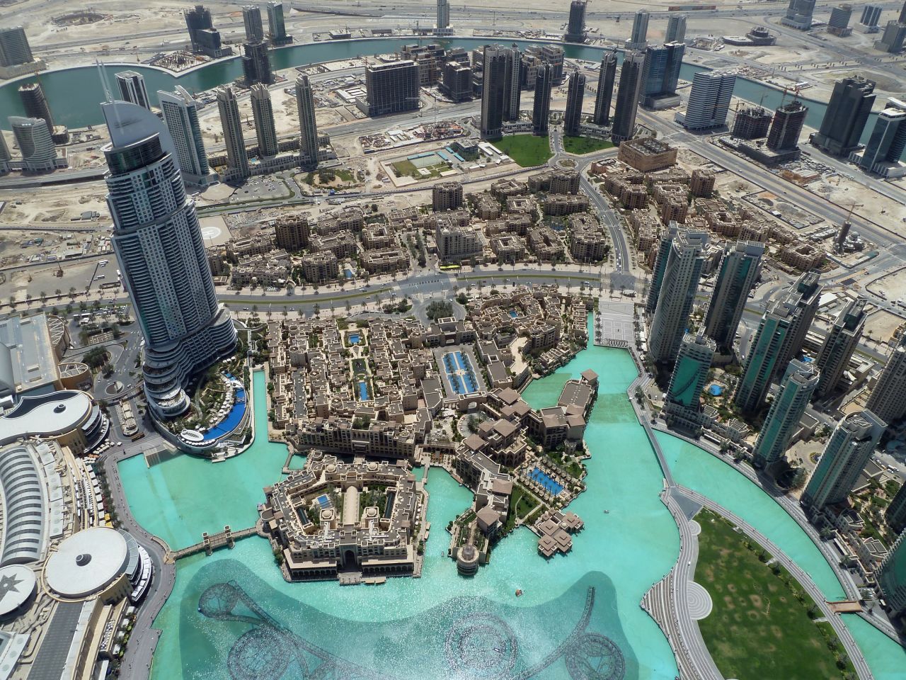 The Burj Khalifa overlooks the Dubai Fountain, Burj Park, Downtown Dubai and the Dubai Mall.