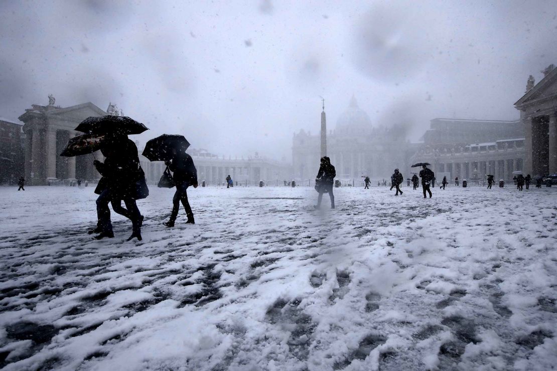 Romans trudge through the snow in St. Peter's Square on Monday. 