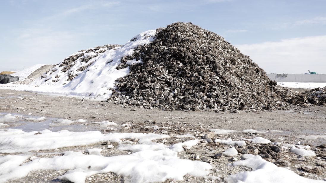 <strong>Matsushima Tourism Association Oyster Shack:</strong> A snow-covered mountain of discarded oyster shells sits in an empty lot outside the Matsushima Tourism Association Oyster Shack.  