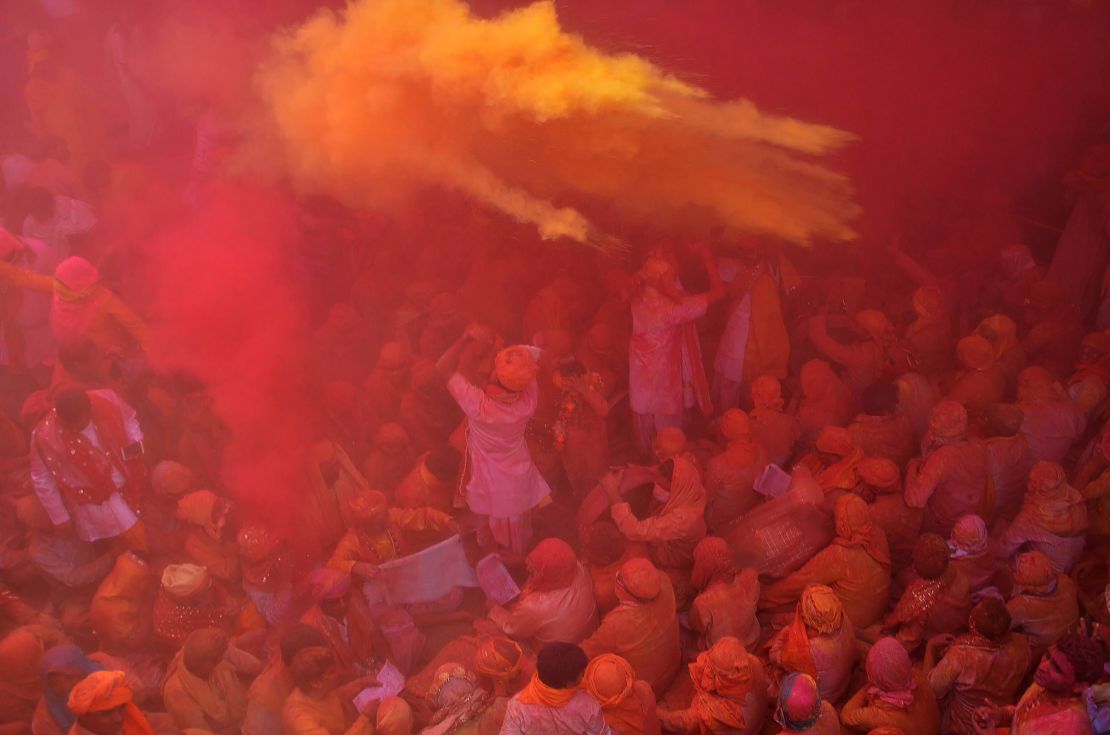 Indian Hindu devotees throw colored powder during celebration of Holi Festival at Sriji temple in Barsana in the northern Indian state of Uttar Pradesh in 2018.
