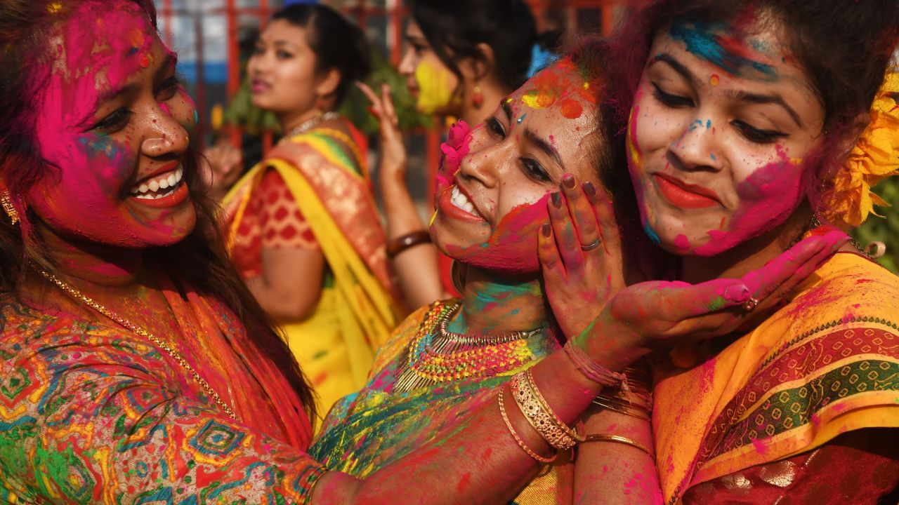 Indian students smear colored powder during an event to celebrate the Hindu festival of Holi in Kolkata on February 26, 2018.

