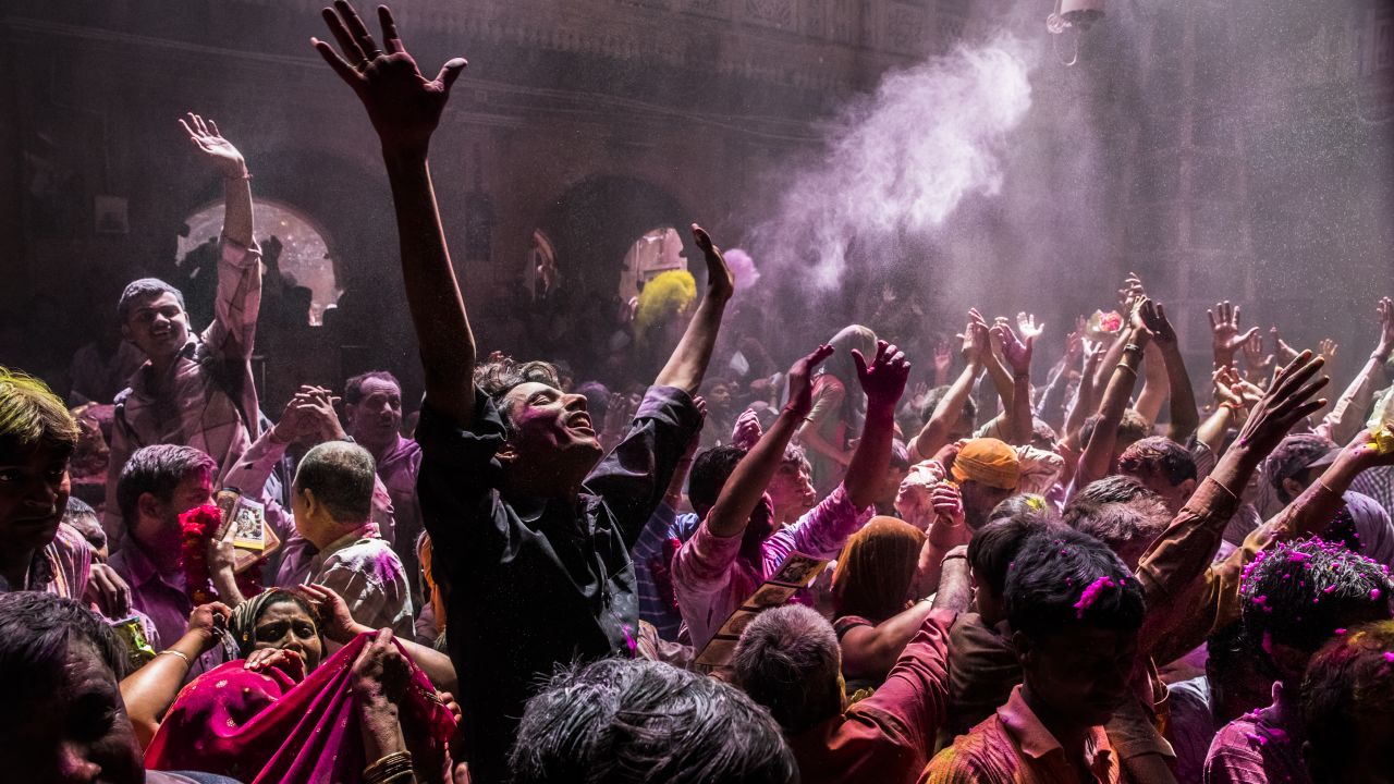 Hindu devotees play with color during Holi celebrations at the Banke Bihari temple on March 27, 2013 in Vrindavan, India. 