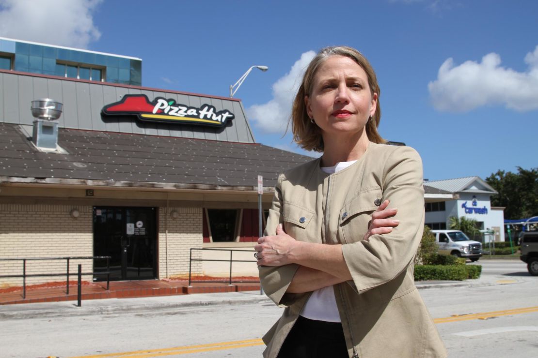 Mary Barzee Flores, now a candidate for Congress, stands outside the Pizza Hut where she was attacked as a teen.