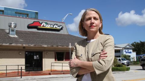 Mary Barzee Flores, now a candidate for Congress, stands outside the Pizza Hut where she was attacked as a teen.