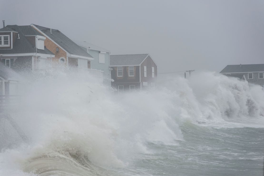 Waves crash against homes along the coast in Scituate, Massachusetts, on Friday, March 2, 2018.