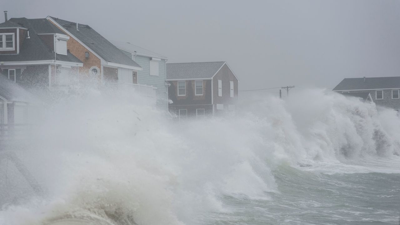 Waves crash against homes along the coast in Scituate, Massachusetts, on Friday, March 2, 2018.