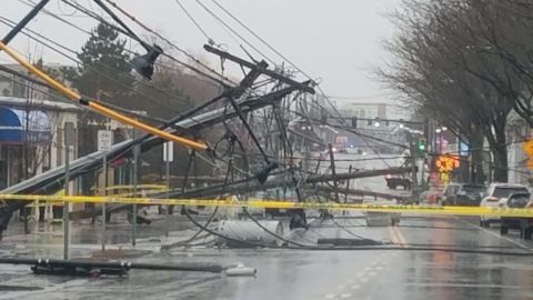 Telephone poles litter the ground Friday, March 2, 2018, in Watertown, Massachusetts.
