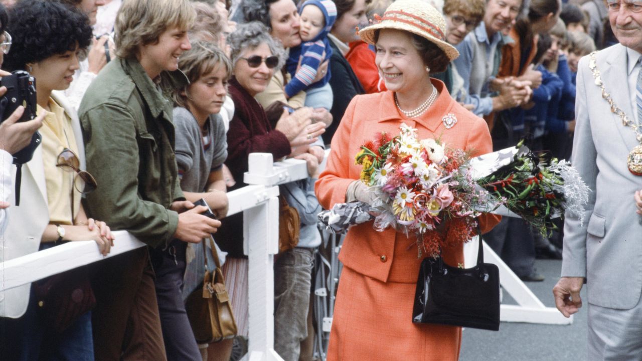 Royal Tour of Australasia by Queen Elizabeth II and Prince Philip, Duke of Edinburgh. They flew out from London to New Zealand where they stayed from the 12th to the 20th October 1981 before gong on to Australia for one day and ending in Sri Lanka from 21st to 25th October. Here Queen Elizabeth II greets enthusiastic crowd members who have gathered to see her. October 1981. (Photo by Mike Maloney/Mirrorpix/Getty Images)