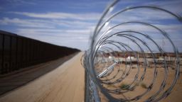 A concertina barbed wire fence stands next to a border fence that separates the U.S. and Mexico in New Mexico, U.S. Photographer: Luke Sharrett/Bloomberg