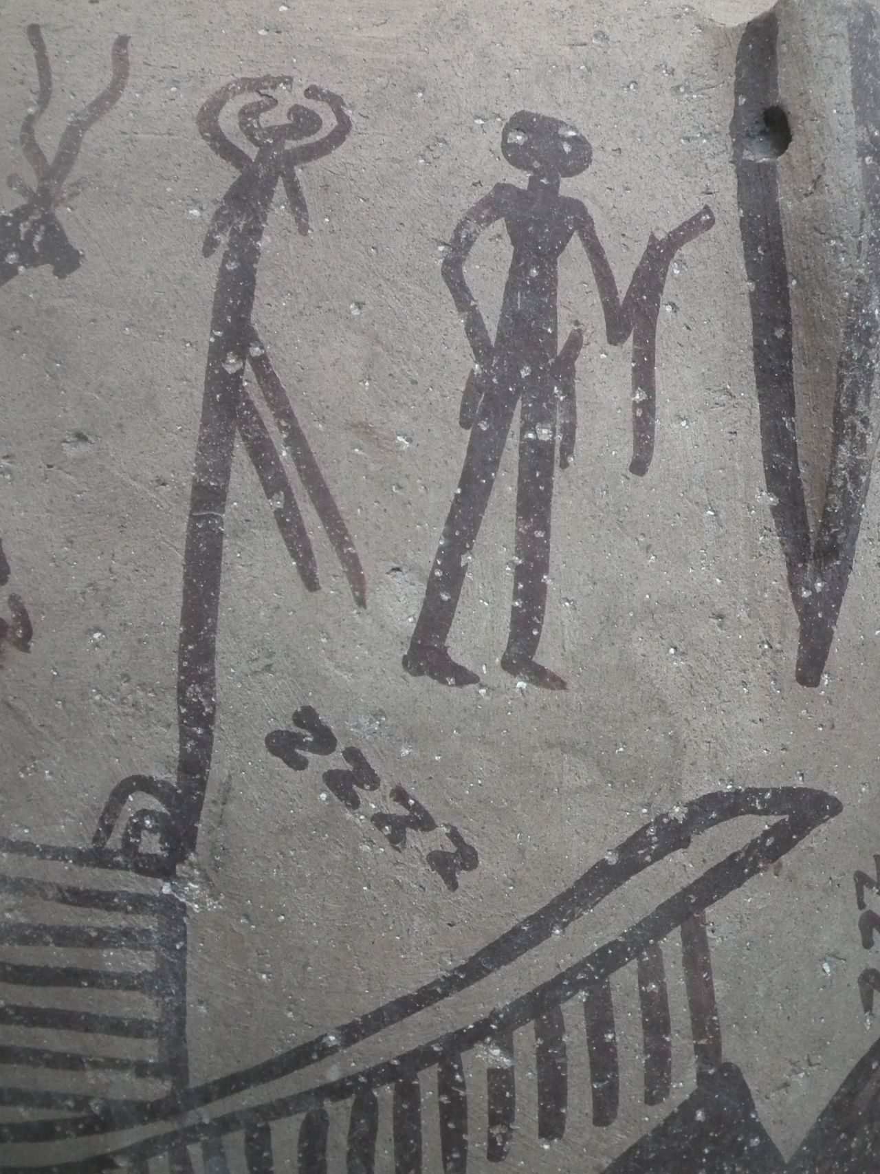 A ritual scene painted on a Predynastic pottery jar depicts multiple S-motifs and a<br />man holding a curved implement, perhaps a crooked stave -- which is thought to be a symbol of power and status. Similar shapes were tattooed on the female mummy.