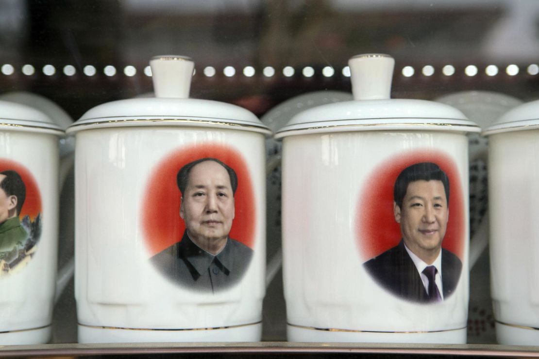 Porcelain cups featuring portraits of Chinese President Xi Jinping, right, and former Chinese leader Mao Zedong stand on display at a store window in Beijing, China, on February 26.