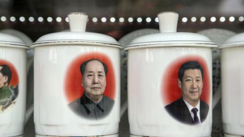 Porcelain cups featuring portraits of Chinese President Xi Jinping, right, and former Chinese leader Mao Zedong stand on display at a store window in Beijing, China, on February 26.