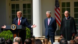 Supreme Court Justice Neil Gorsuch, center, along side Justice Anthony Kennedy, right, listen as President Donald Trump speaks on April 10, 2017 in Washington, D.C.