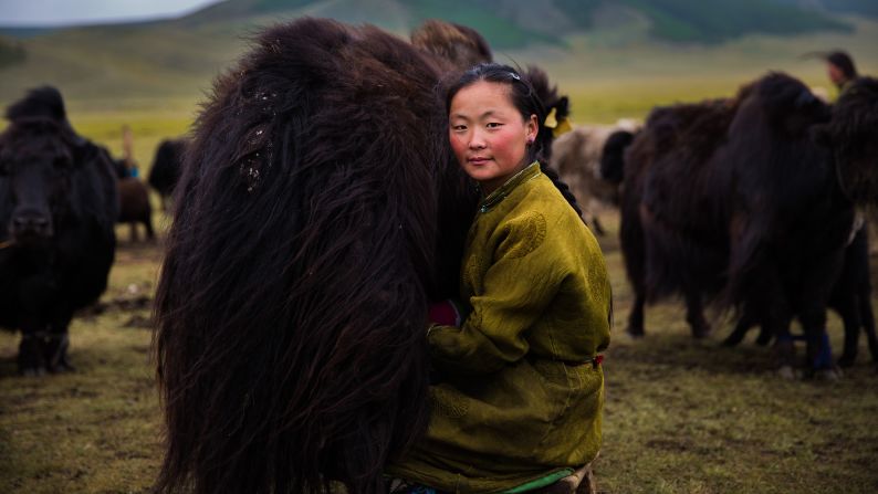 <strong>Central Mongolia:</strong> "It was a day of August when I visited these isolated lands of Central Mongolia, but it was still freezing cold. In this harsh environment, I noticed this graceful woman who was milking a yak. Women shine like stars in all environments. We just have to open our eyes and see the true beauty."
