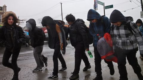 Schoolchildren face off against the wind and rain as they walk home in Brooklyn, New York, on March 2.