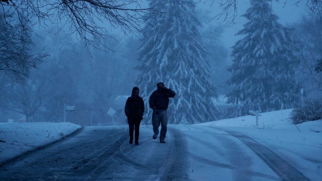 A family heads down a snowy street in Marple Township, Pennsylvania, on March 2.