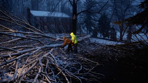 Workers David Boardly, left, and James Ockimey clear a downed tree in Marple Township, Pennsylvania, on March 2.