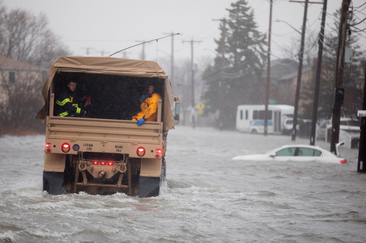 A National Guard vehicle carries emergency workers to residents trapped by floodwaters in Quincy on March 2.