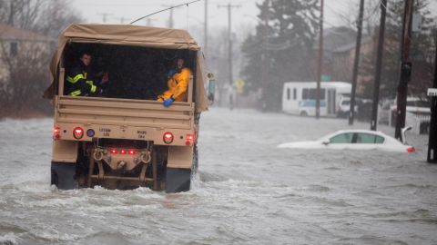 A National Guard vehicle takes emergency workers to rescue flood-trapped residents Friday in Quincy, Massachusetts.