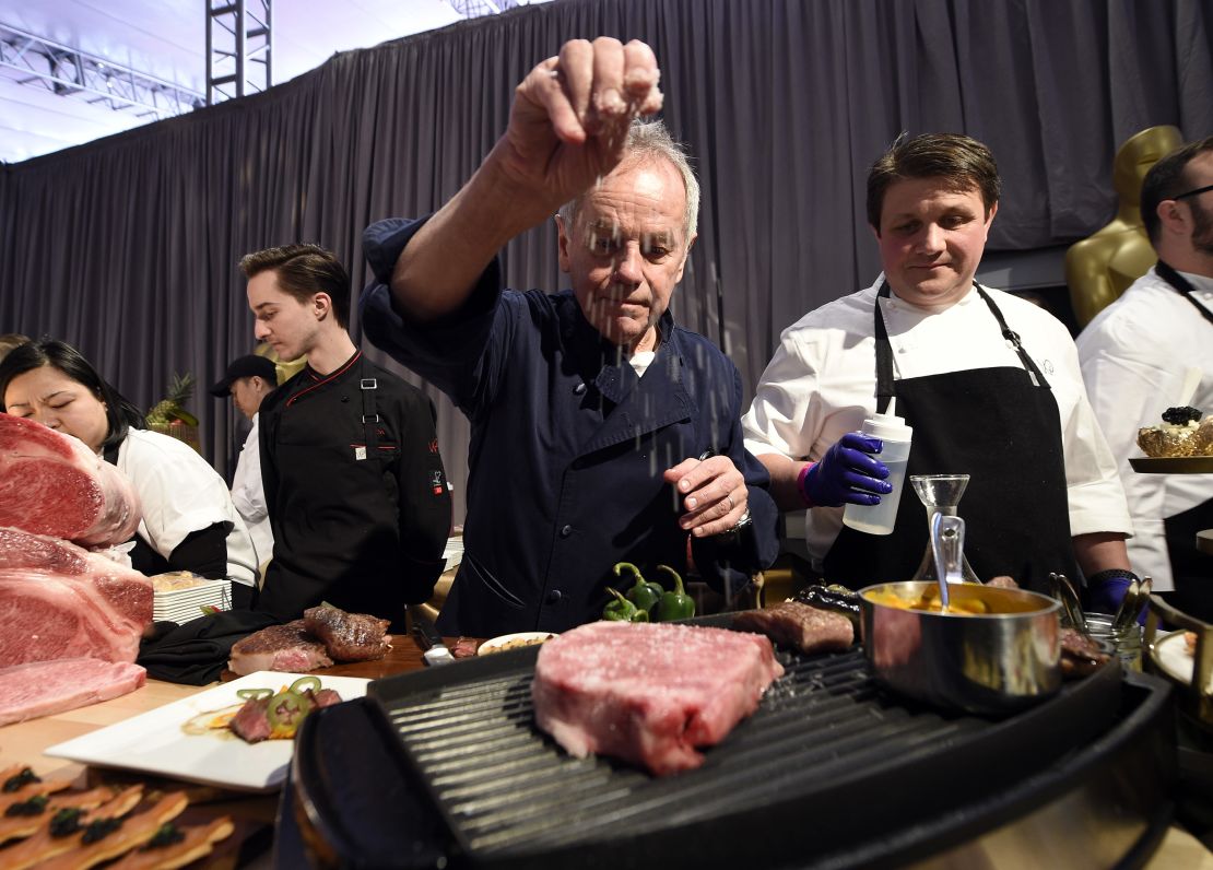 Master chef Wolfgang Puck (center) makes it rain salt on a Miyazaki Wagyu beef, with chef Eric Klein (right) looking on during 90th Annual Academy Awards Governors Ball Press Preview in Hollywood, California, March 1, 2018. 