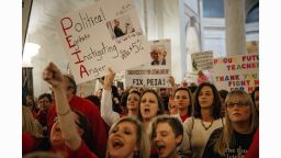 Striking school workers hold signs and chant inside the West Virginia Capitol in Charleston, West Virginia, U.S., on Friday, March 2, 2018. A week ago, thousands of public school teachers in West Virginia went out on strike, a rare but familiar union-organized action to protest low wages and rising health-care costs. Tuesday night, state union leaders and the Governor Jim Justice reached a deal, and the teachers were expected to be back at work on Thursday, but hey didn't go. Unsatisfied with the resolution, they stayed on the picket line, mounting one of the country's biggest unauthorized "wildcat" strikes in decades. Photographer: Scott Heins/Bloomberg via Getty Images