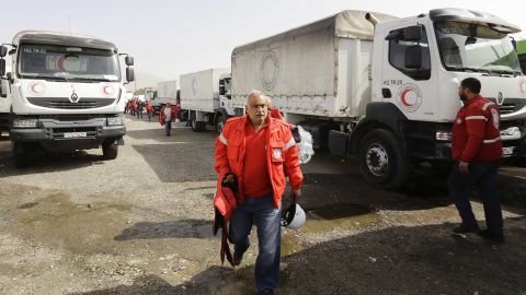 Vehicles carrying aid wait at the al-Wafideen checkpoint on the outskirts of Damascus.