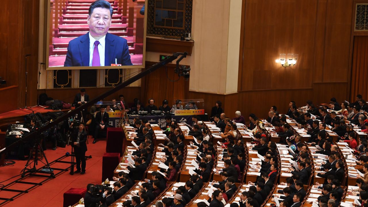 A live image of Chinese President Xi Jinping is seen on a screen above delegates as they listen to Premier Li Keqiang's speech during the opening session of the National People's Congress in the Great Hall of the People in Beijing on March 5, 2018.
