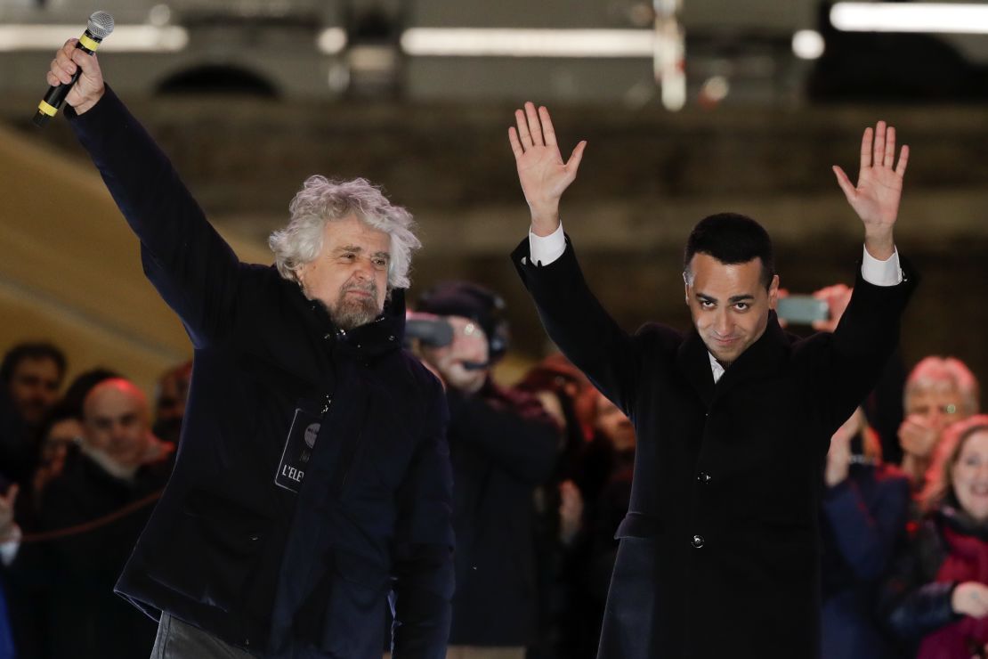 Five Star Movement leader Luigi di Maio (R) waves to supporters at a rally with party founder Beppe Grillo (L) in Rome on Friday.