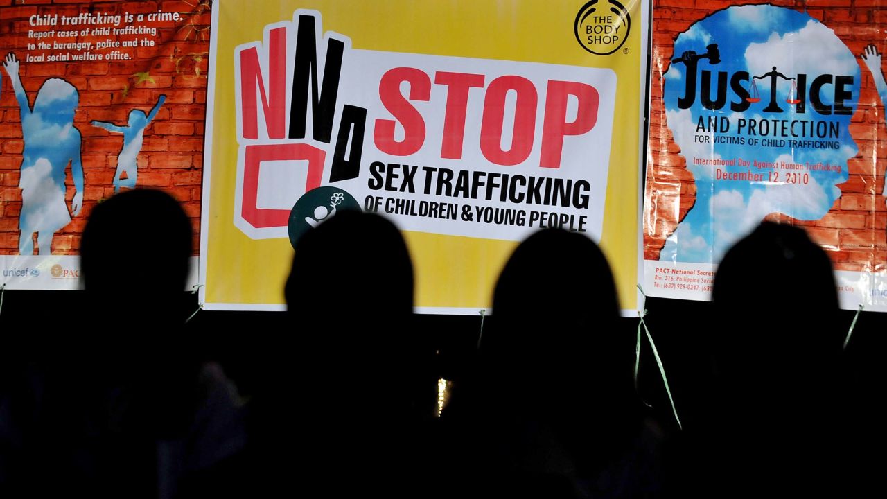 TO GO WITH AFP STORY "LIFESTYLE-IT-PHILIPPINES-CRIME-PORNOGRAPHY" by Cecil MorellaChildren are silhouetted in front of posters displayed during a prayer for Justice and Protection against Sex Trafficking of Children and Young People in Quezon City suburban Manila on December 12, 2010, as part of the annual observance of  International Day against Human Trafficking. Cybersex dens are a growing problem in the impoverished Southeast Asian nation that has long struggled to curb child prostitution, according to law enforcers and social workers. AFP PHOTO/JAY DIRECTO (Photo credit should read JAY DIRECTO/AFP/Getty Images)