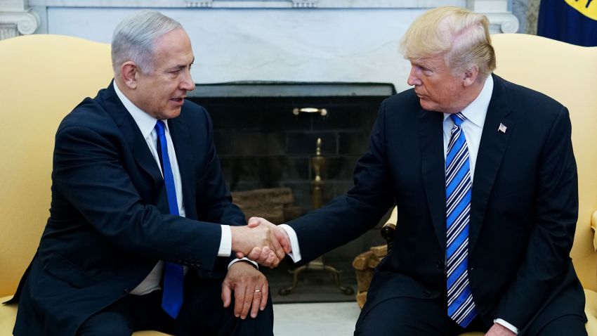 US President Donald Trump shakes hands with Israel's Prime Minister Benjamin Netanyahu in the Oval Office of the White House on  March 5, 2018 in Washington, DC.
President Donald Trump said he "may" attend the opening of a controversial new US embassy in Jerusalem, a fraught prospect designed to underscore close ties with Benjamin Netanyahu, whom he hosted Monday.Trump warmly welcomed the embattled prime minister to the White House, claiming US-Israel ties had "never been better" and floating a May trip that would be a major security and diplomatic challenge.
 / AFP PHOTO / MANDEL NGAN        (Photo credit should read MANDEL NGAN/AFP/Getty Images)