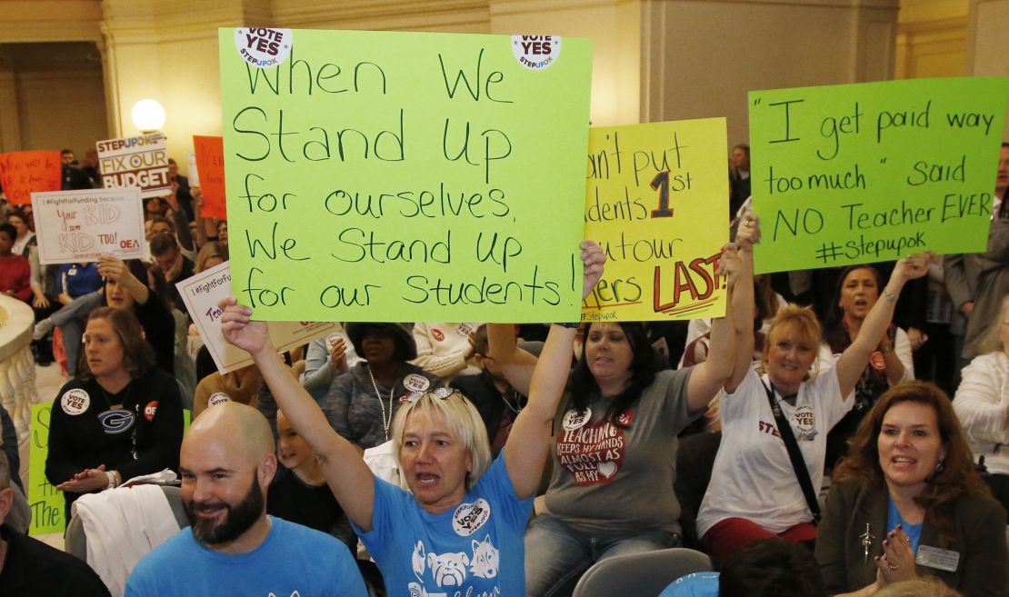 Oklahoma school personnel cheer February 12 in support of a proposed teacher pay raise at the state capitol. 