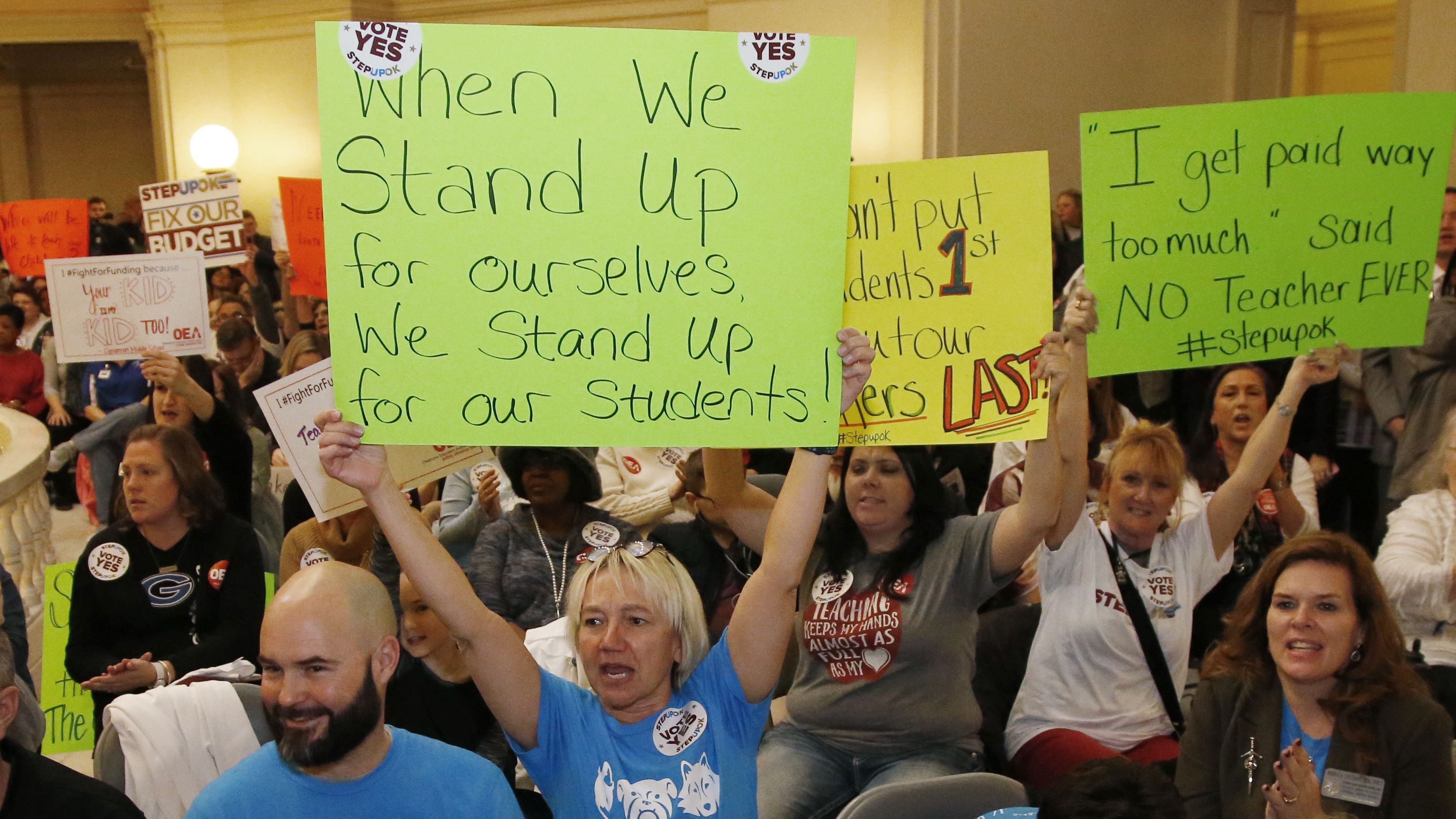 Oklahoma school personnel cheer February 12 in support of a proposed teacher pay raise at the state capitol. 