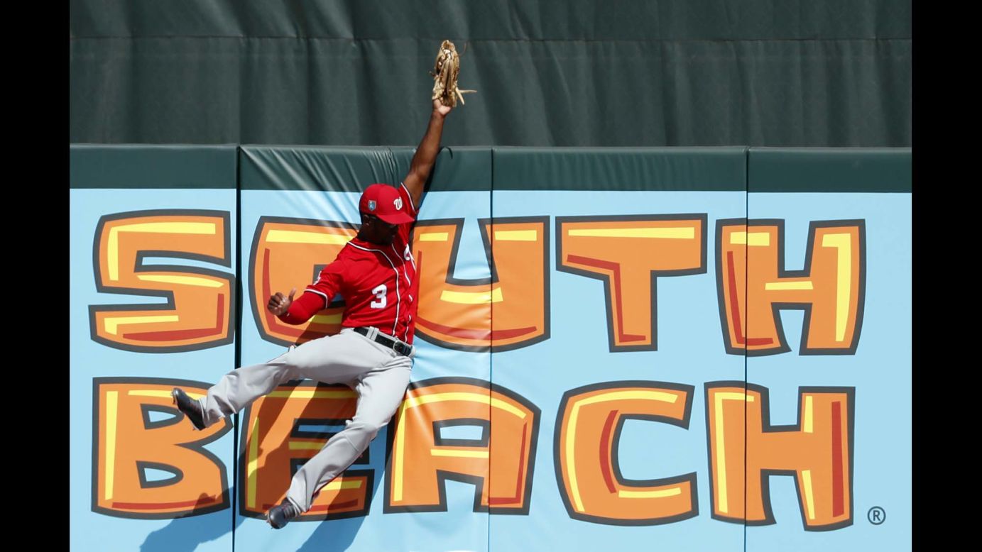 Washington Nationals center fielder Michael A. Taylor leaps at the wall to make a catch during a spring-training game in Jupiter, Florida, on Wednesday, February 28.