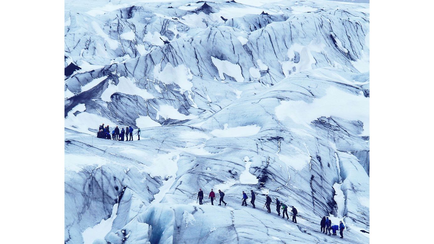 A group explore the Svartisen glacier. Svart means black in Norwegian, and the hotel name is a nod to the dark blue ice of the glacier that slithers down a nearby mountainside.