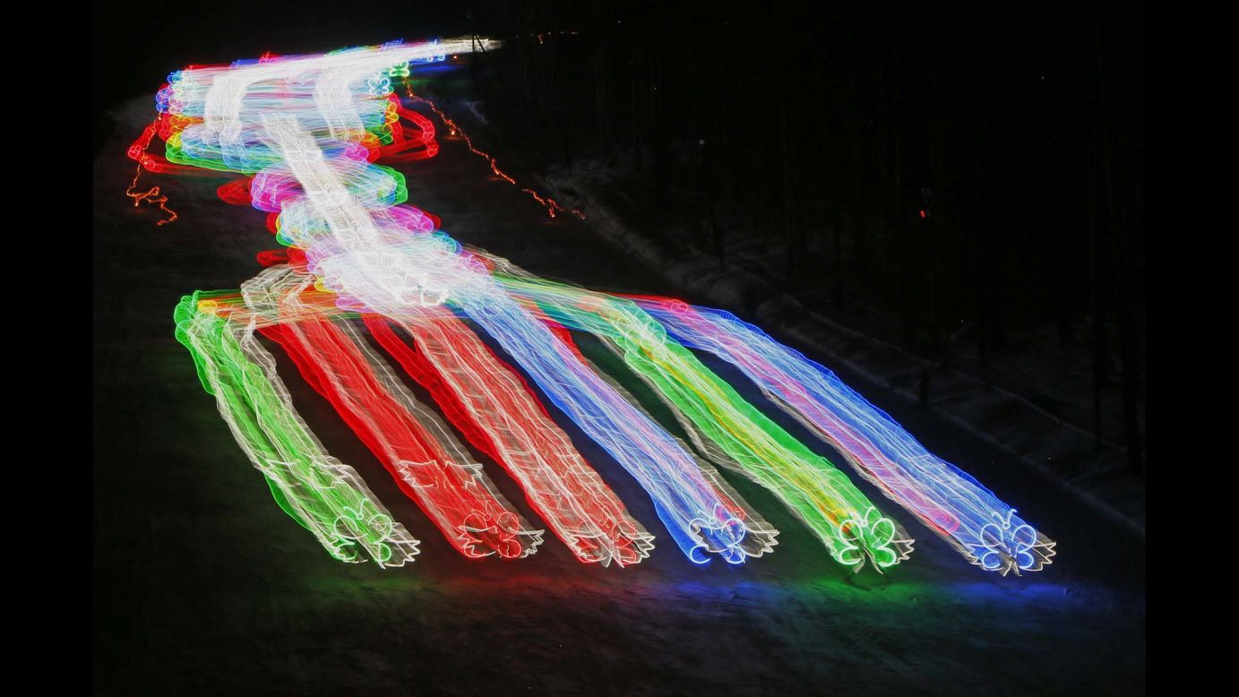 In this long-exposure photo, members of a skiing school wear lighted costumes as they make their way down a slope in Krasnoyarsk, Russia, on Saturday, March 3.