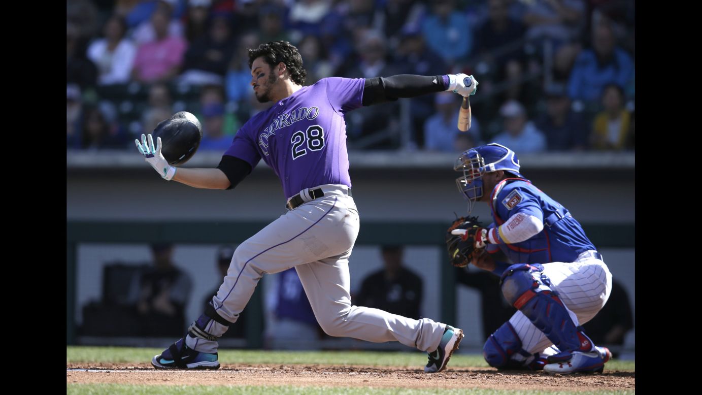 Colorado's Nolan Arenado loses his helmet as he strikes out during a spring-training game on Thursday, March 1.