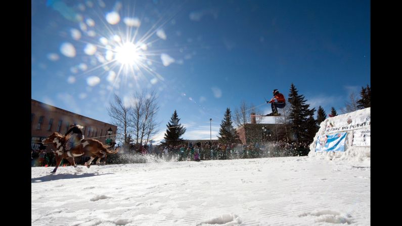 Amber West rides a horse to pull Bruce Stott during a skijoring competition in Leadville, Colorado, on Saturday, March 3. In skijoring, a skier navigates jumps and slalom gates while grabbing rings for points. Leadville has been hosting skijoring competitions since 1949.